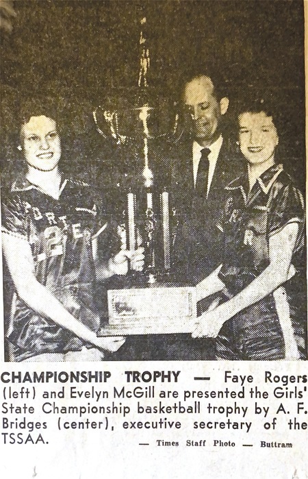 B&W newspaper photo of 1959 State Champions Faye Rogers and Evelyn McGill holding the state championship trophy for Porter High School girls basketball.